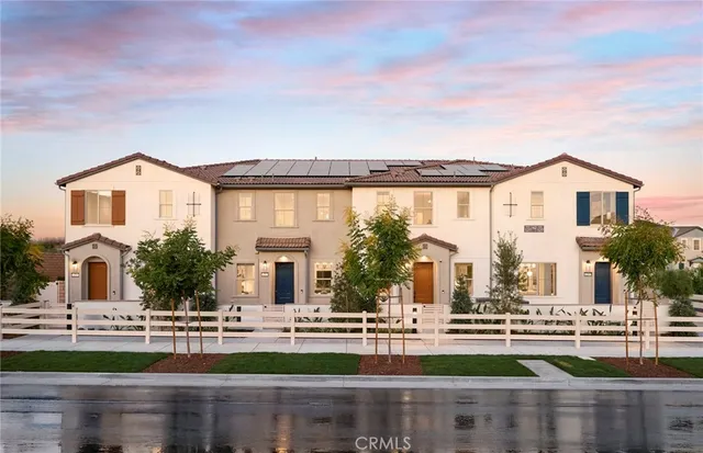 front view of house with a big yard and large trees