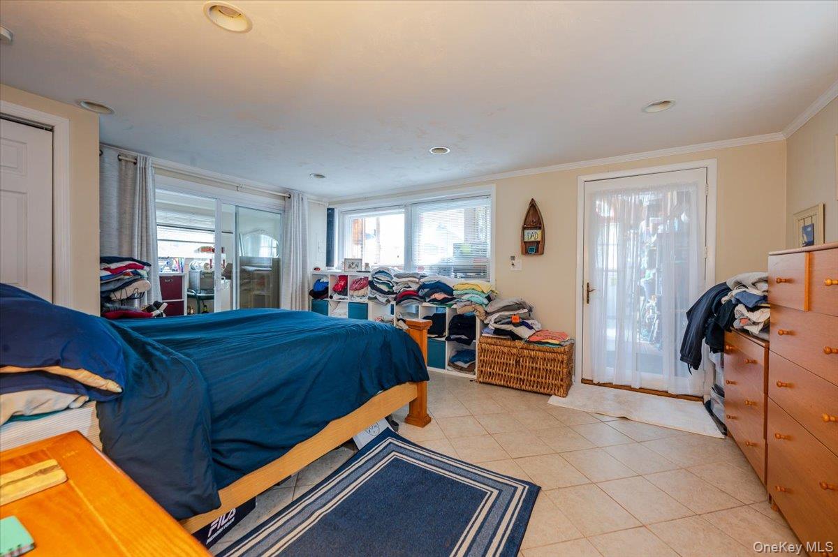 1 Bellmore Avenue Point Lookout, NY 11569 - Photo 11 of 21 a bed room with a bed and a chair