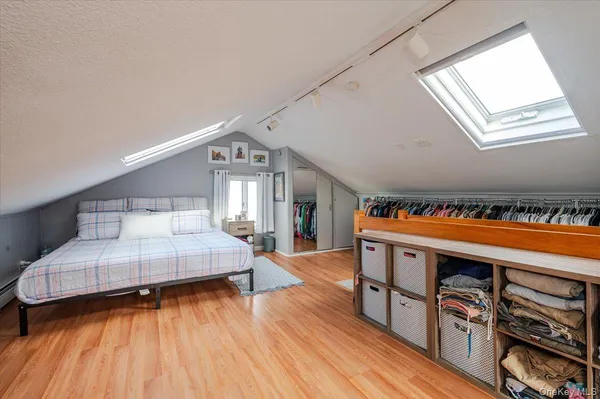 a bedroom with furniture and a wooden floor