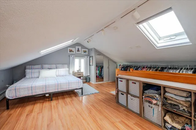 a bedroom with furniture and a wooden floor