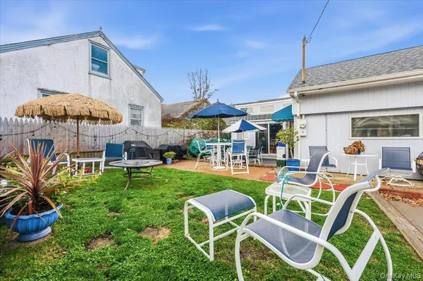a patio with a table and chairs