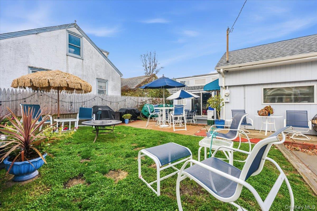 1 Bellmore Avenue Point Lookout, NY 11569 - Photo 17 of 21 a patio with a table and chairs