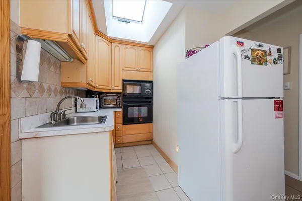 a white refrigerator freezer sitting inside of a kitchen