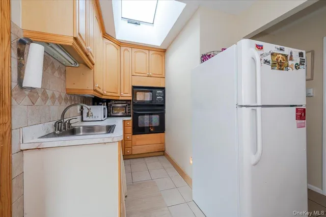a white refrigerator freezer sitting inside of a kitchen