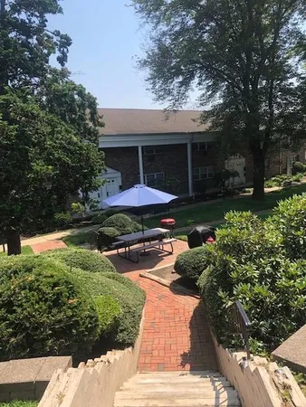 a front view of a house with garden