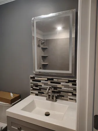 a bathroom with a sink and a mirror
