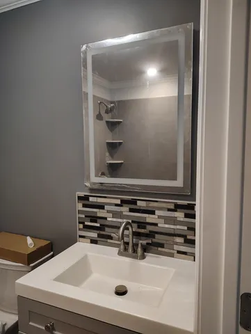 a bathroom with a sink and a mirror