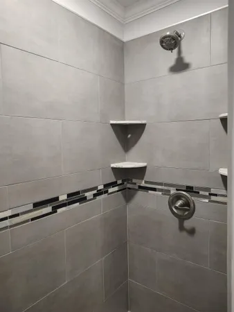 a bathroom with a window and a shower