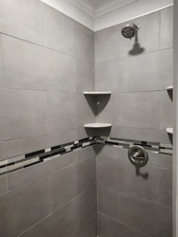 a bathroom with a window and a shower