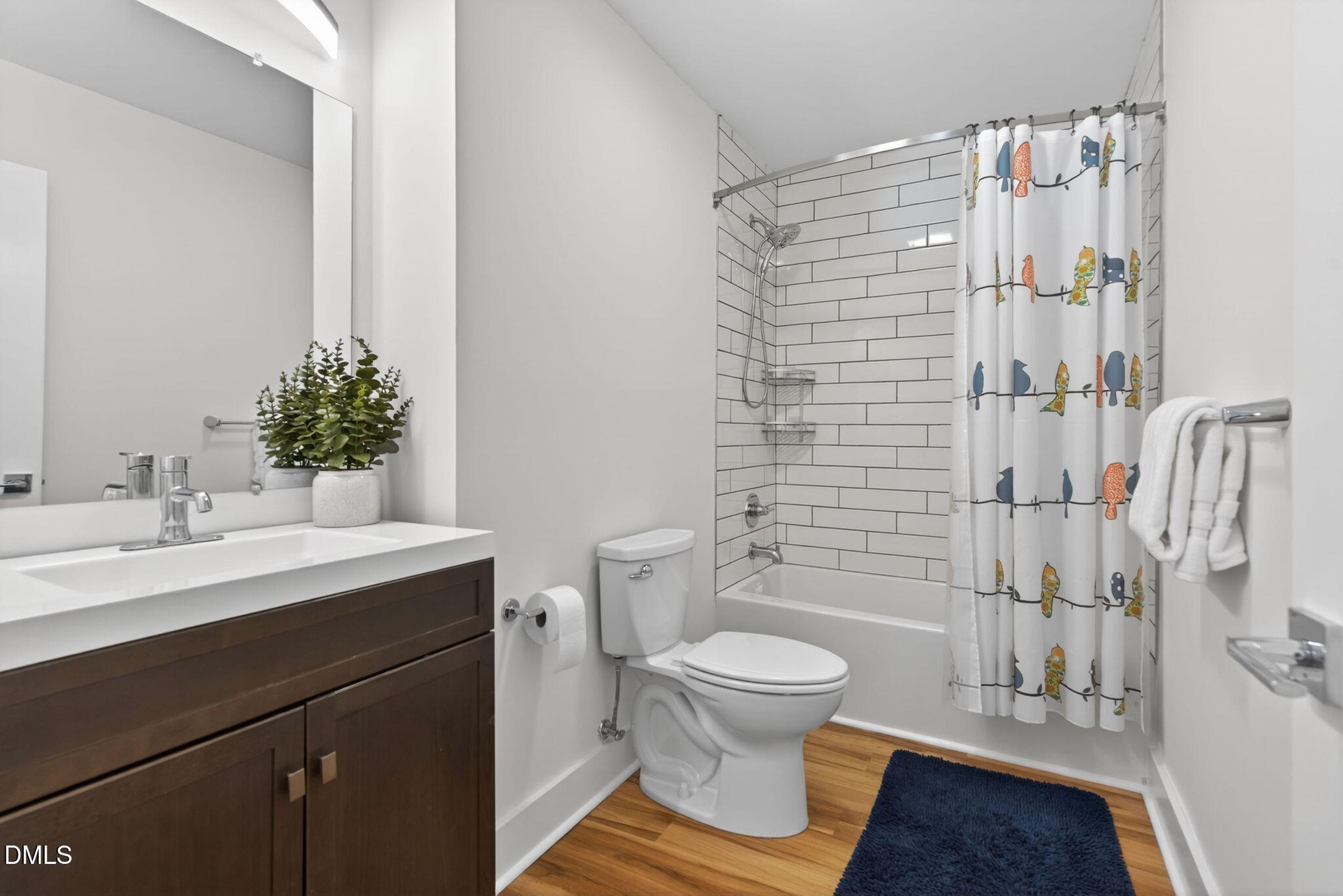 7149 Sandy Creek Drive Raleigh, NC 27615 - Photo 18 of 23 a bathroom with a sink toilet and shower