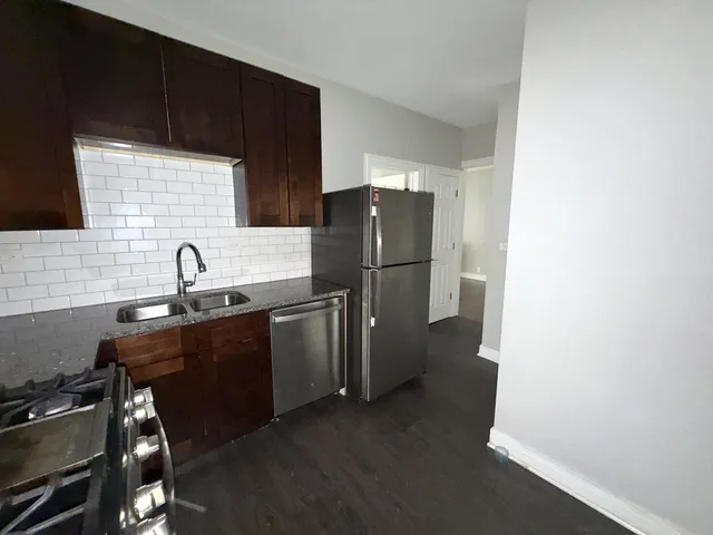 a kitchen with a refrigerator and a sink