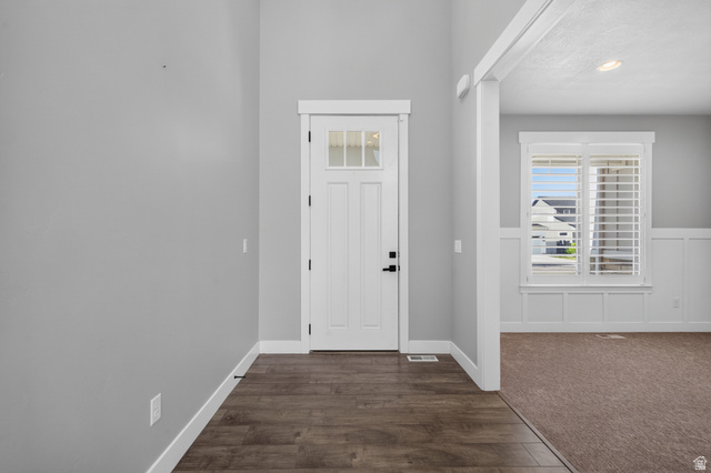 36 West Syracuse Road Vineyard, UT 84059 - Photo 7 of 56 Entryway featuring wood-finish flooring, a paneled door with glass inserts, and a transom window
