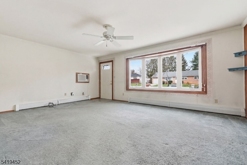 808 Charles Road Phillipsburg, NJ 08865 - Photo 11 of 33 an empty room with windows and ceiling fan