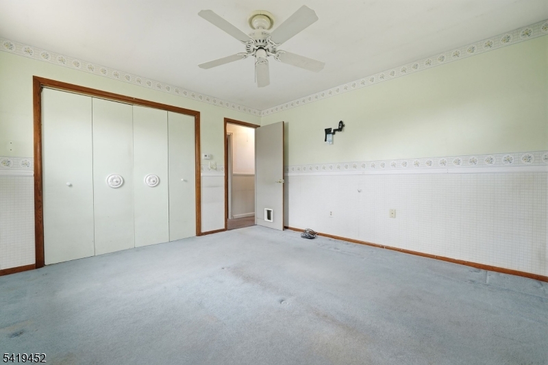 808 Charles Road Phillipsburg, NJ 08865 - Photo 24 of 33 an empty room with a ceiling fan and a window
