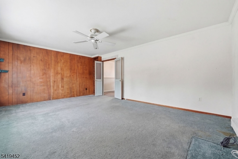 808 Charles Road Phillipsburg, NJ 08865 - Photo 10 of 33 an empty room with chandelier fan and windows