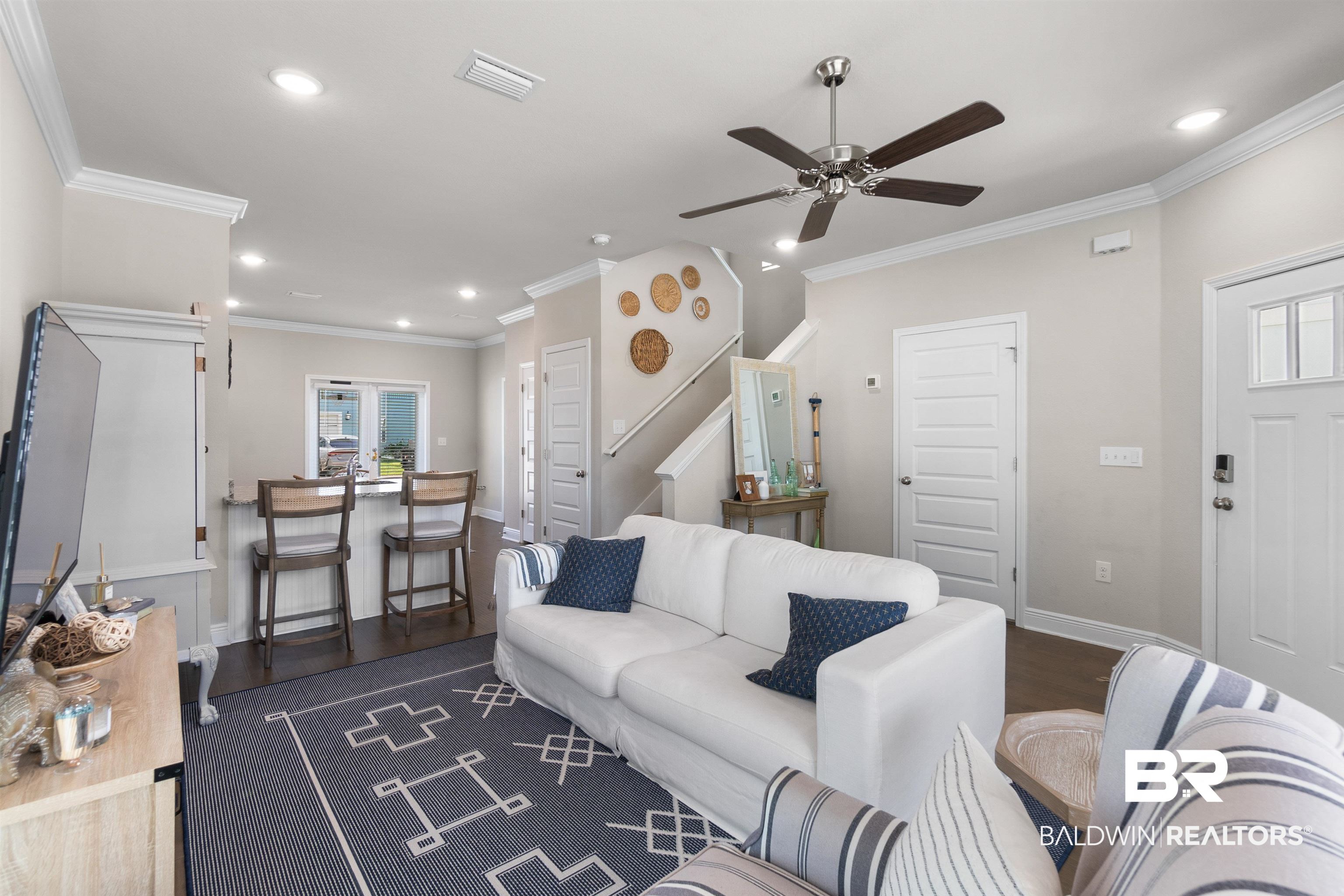 23975 Cottage Loop Orange Beach, AL 36561 - Photo 3 of 23 Living room featuring dark wood-type flooring, ceiling fan, and crown molding