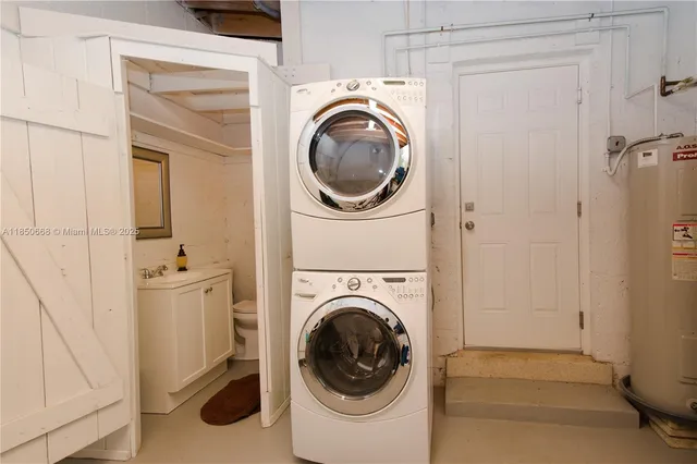 a utility room with sink dryer and washer