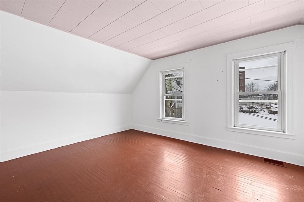 3 Ely Street Worcester, MA 01610 - Photo 12 of 17 an empty room with wooden floor and windows