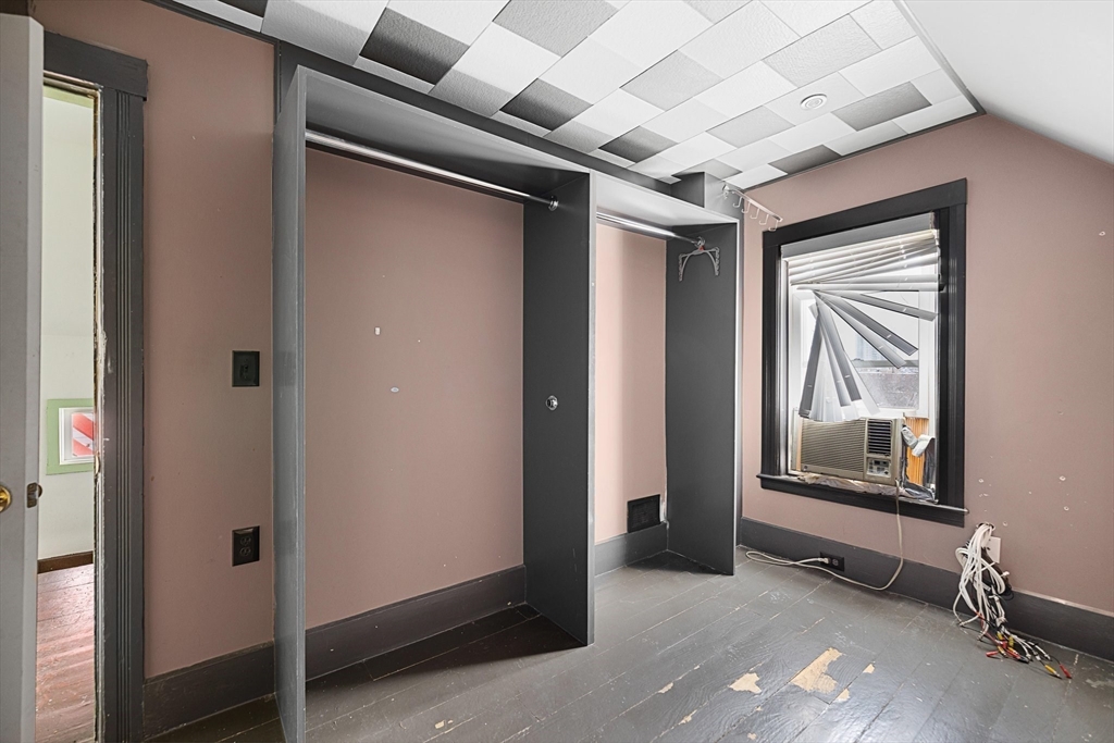 3 Ely Street Worcester, MA 01610 - Photo 13 of 17 a view of a hallway with wooden floor and windows