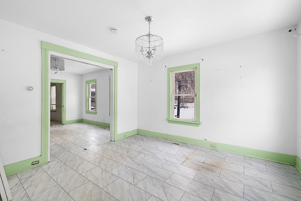 3 Ely Street Worcester, MA 01610 - Photo 5 of 17 a view of a hallway with windows and chandelier