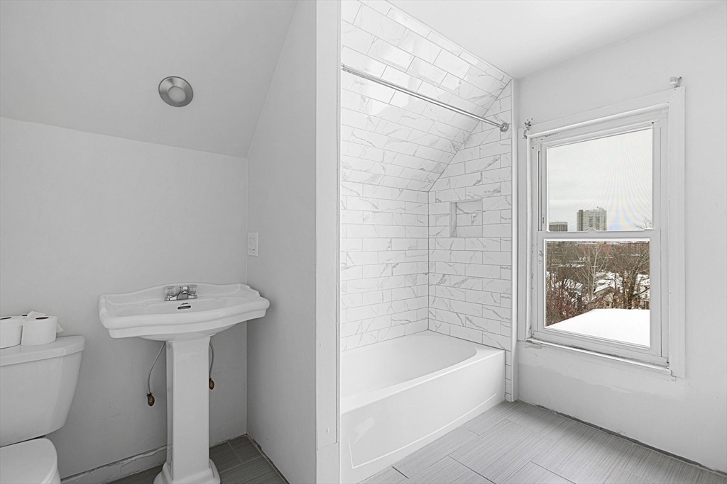 3 Ely Street Worcester, MA 01610 - Photo 9 of 17 a bathroom with a sink mirror toilet and bathtub