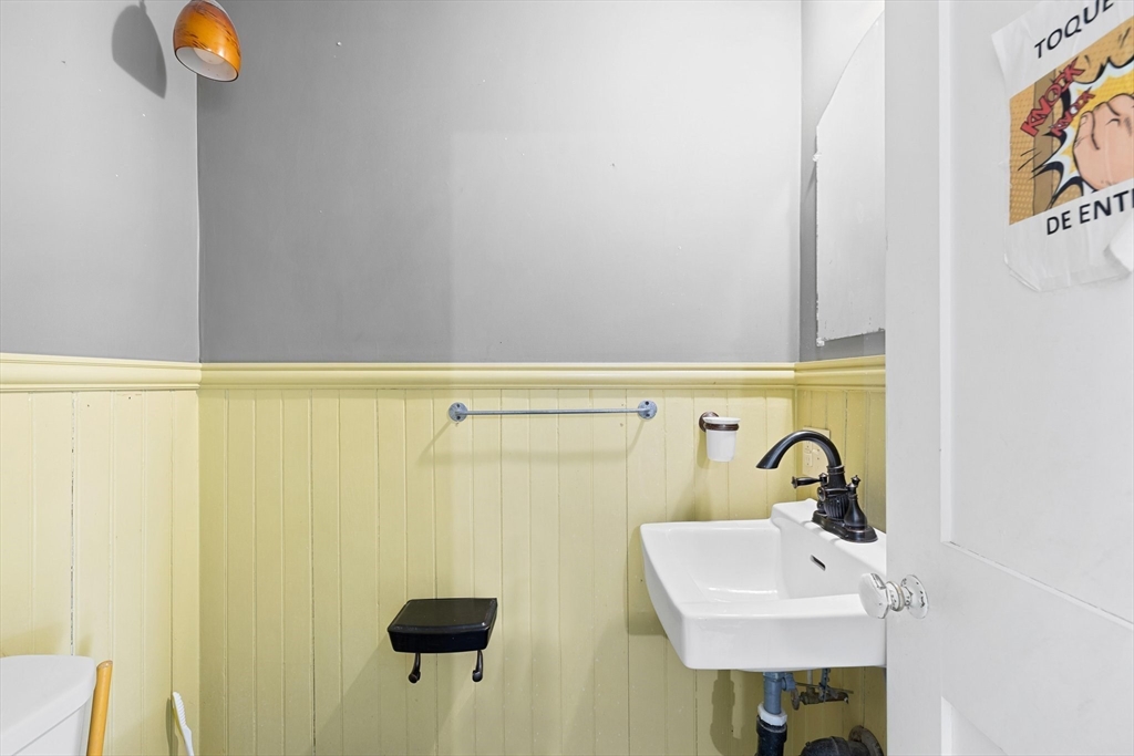 3 Ely Street Worcester, MA 01610 - Photo 10 of 17 a bathroom with a sink a mirror and shower