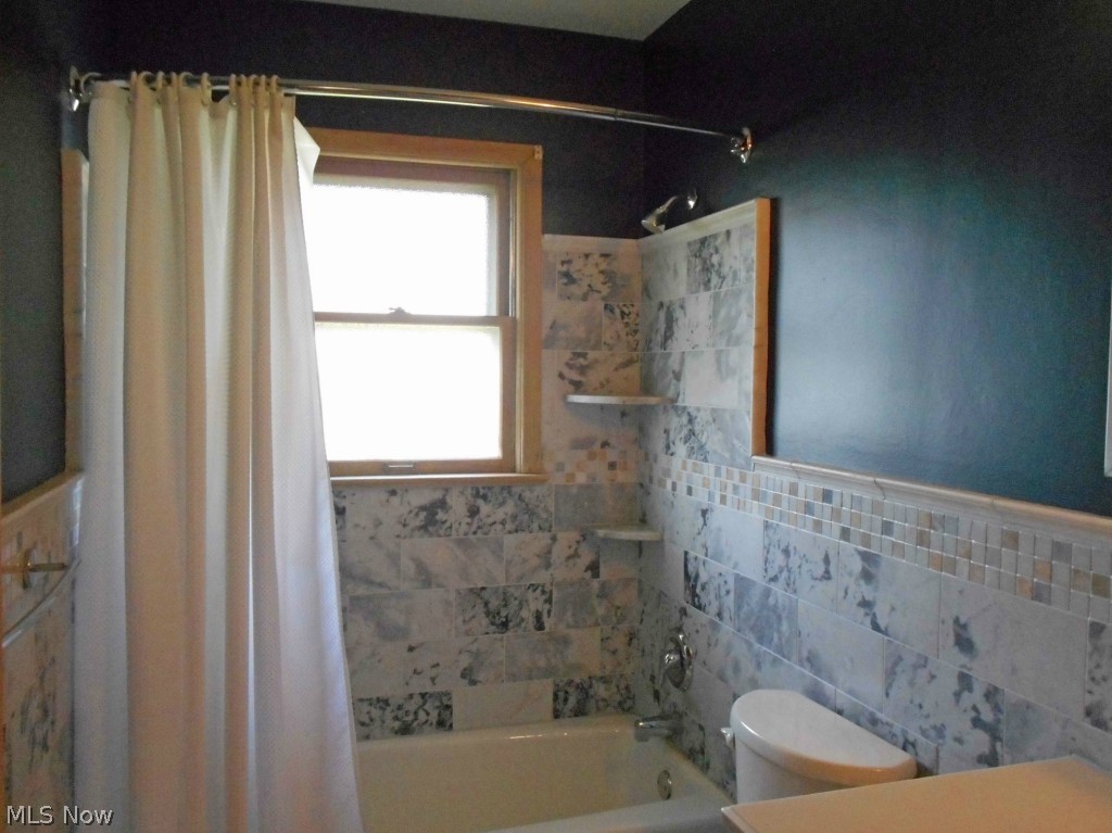 12311 Orme Road Garfield Heights, OH 44125 - Photo 7 of 12 Updated Bathroom with Travertine Wainscot.