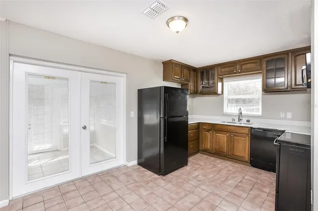 a kitchen with granite countertop a refrigerator and a sink