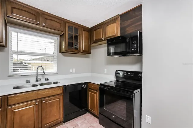 a kitchen with stainless steel appliances granite countertop a stove microwave and sink