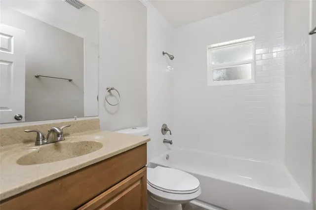 a bathroom with a sink toilet tub and shower