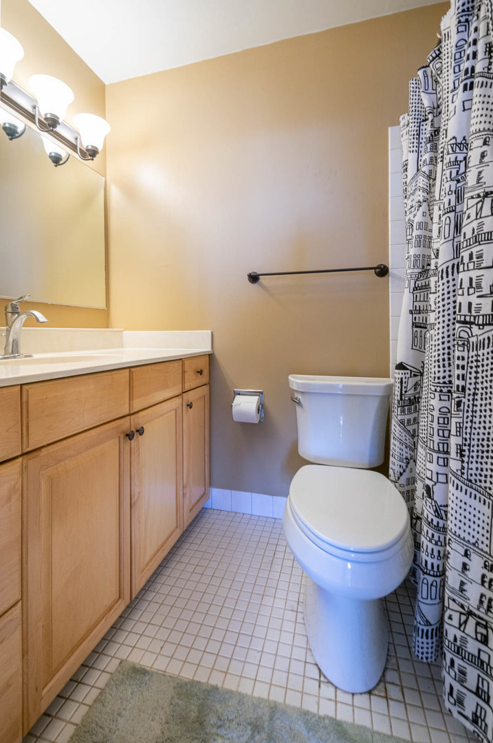 5445 North Sheridan Road, Unit 1701 Chicago, IL 60640 - Photo 10 of 11 a bathroom with a toilet and a shower