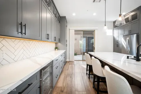 a large kitchen with granite countertop lots of counter space dining table and chairs