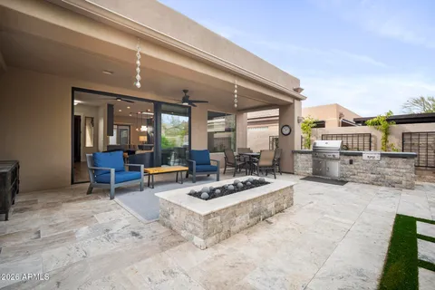 a view of a patio with table and chairs and potted plants