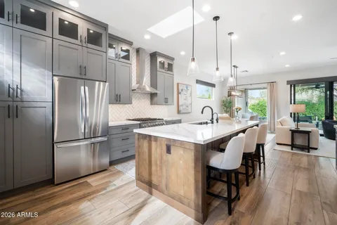 a living room with furniture tv and wooden floor