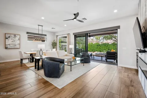 a living room with furniture and a wooden floor