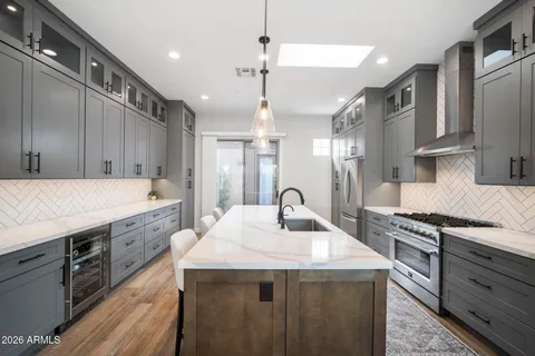 a kitchen with a sink stove and cabinets