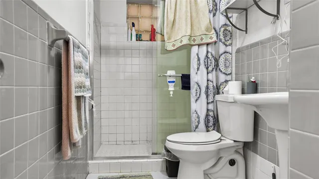 a white toilet sitting next to a bathroom sink