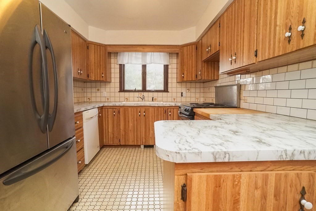 2 Perkins Lane Acushnet, MA 02743 - Photo 14 of 41 a kitchen with stainless steel appliances granite countertop a sink refrigerator and cabinets