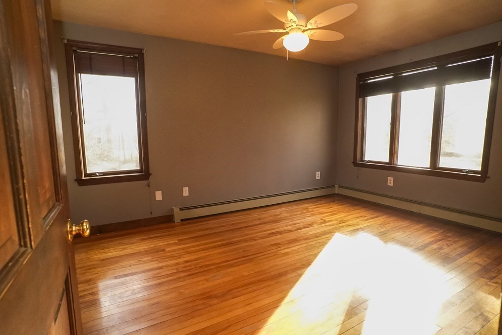 2 Perkins Lane Acushnet, MA 02743 - Photo 16 of 41 a view of an empty room with wooden floor and a window