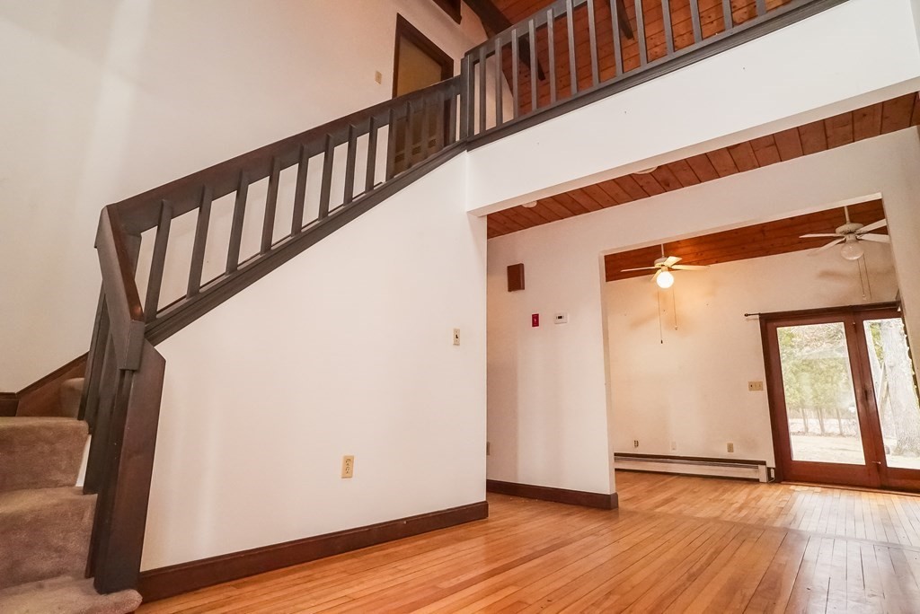 2 Perkins Lane Acushnet, MA 02743 - Photo 5 of 41 a view of a hallway with wooden floor and staircase