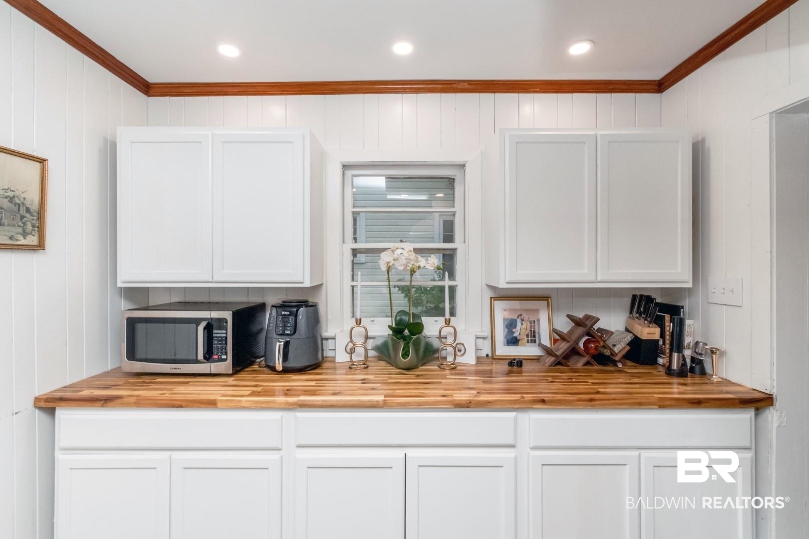 20 Kirby Street Mobile, AL 36607 - Photo 14 of 35 Bar featuring wooden walls, white cabinets, and ornamental molding