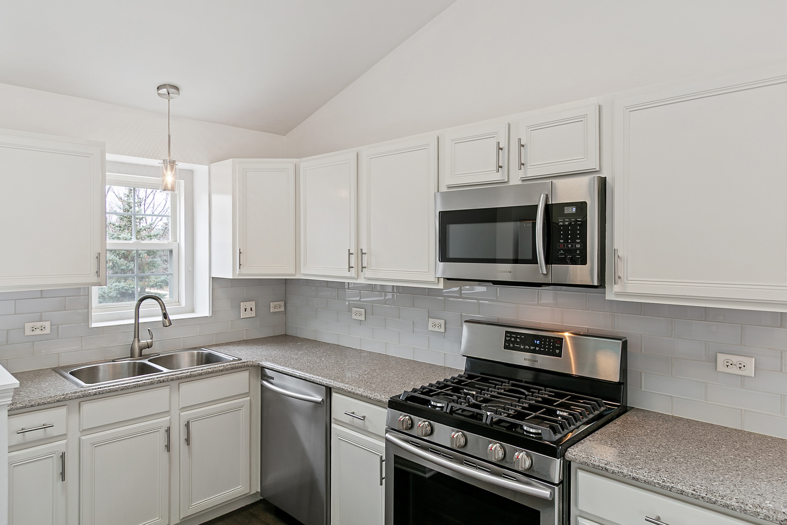 2604 Sheehan Court, Unit 204 Naperville, IL 60564 - Photo 8 of 19 a kitchen with stainless steel appliances a sink a stove a microwave and cabinets