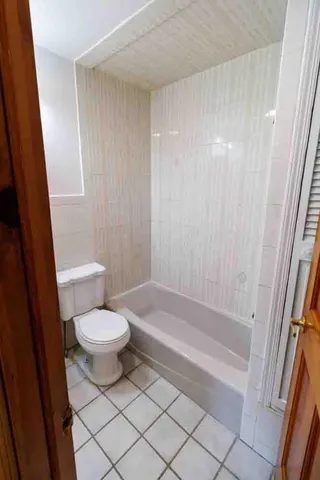 a bathroom with a toilet and a bathtub