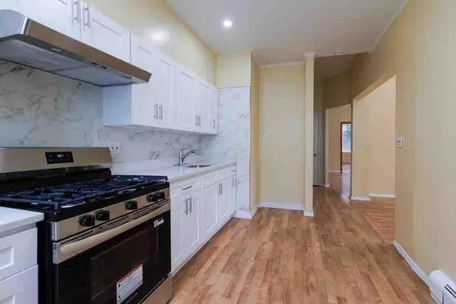 a kitchen with wooden floors and a stove
