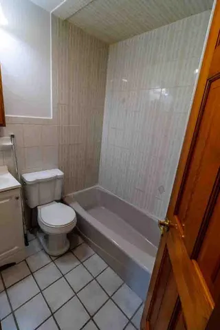 a bathroom with a toilet a sink and bathtub