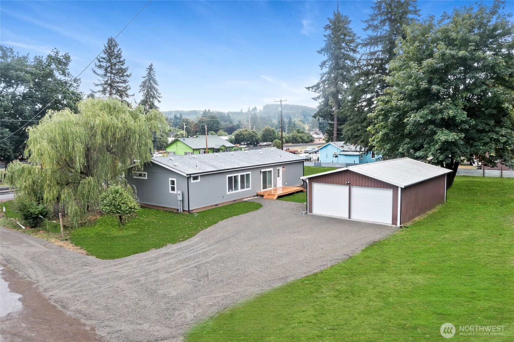 309 Sumner Street Bucoda, WA 98530 - Photo 1 of 35 a aerial view of a house with a yard and large trees