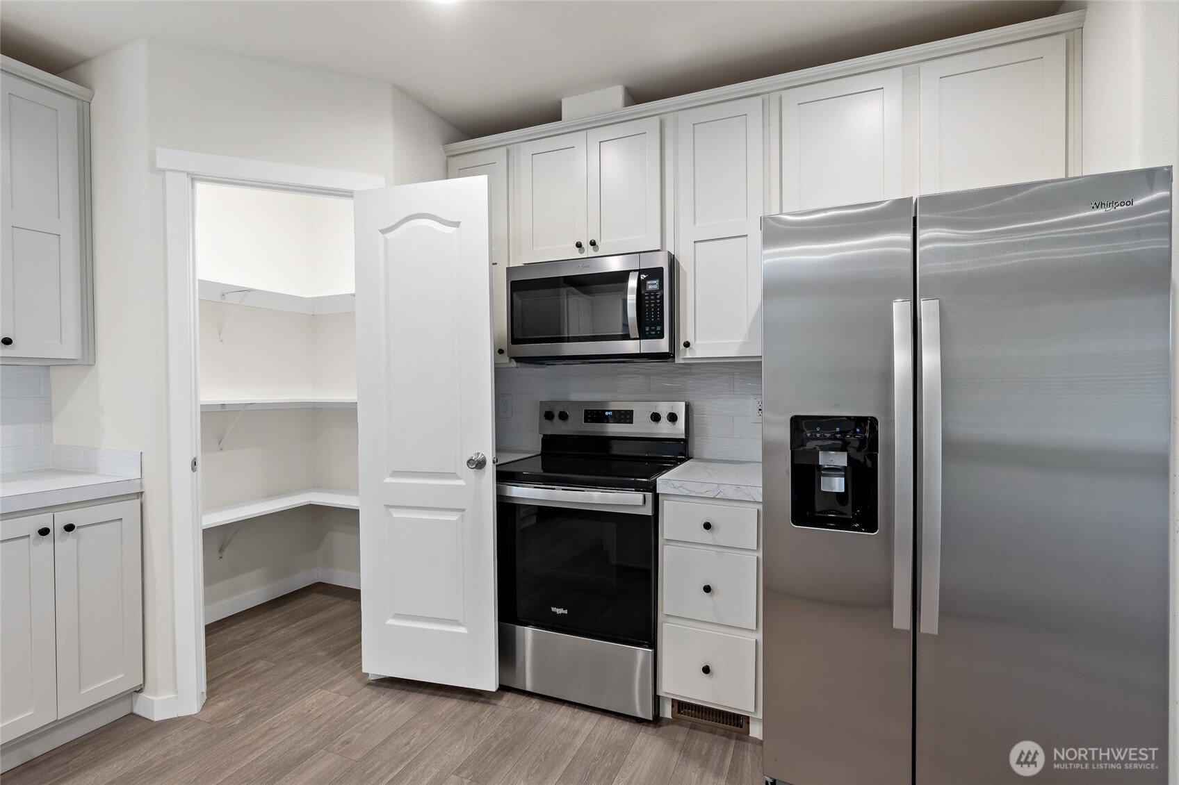 309 Sumner Street Bucoda, WA 98530 - Photo 13 of 35 a kitchen with white cabinets and stainless steel appliances