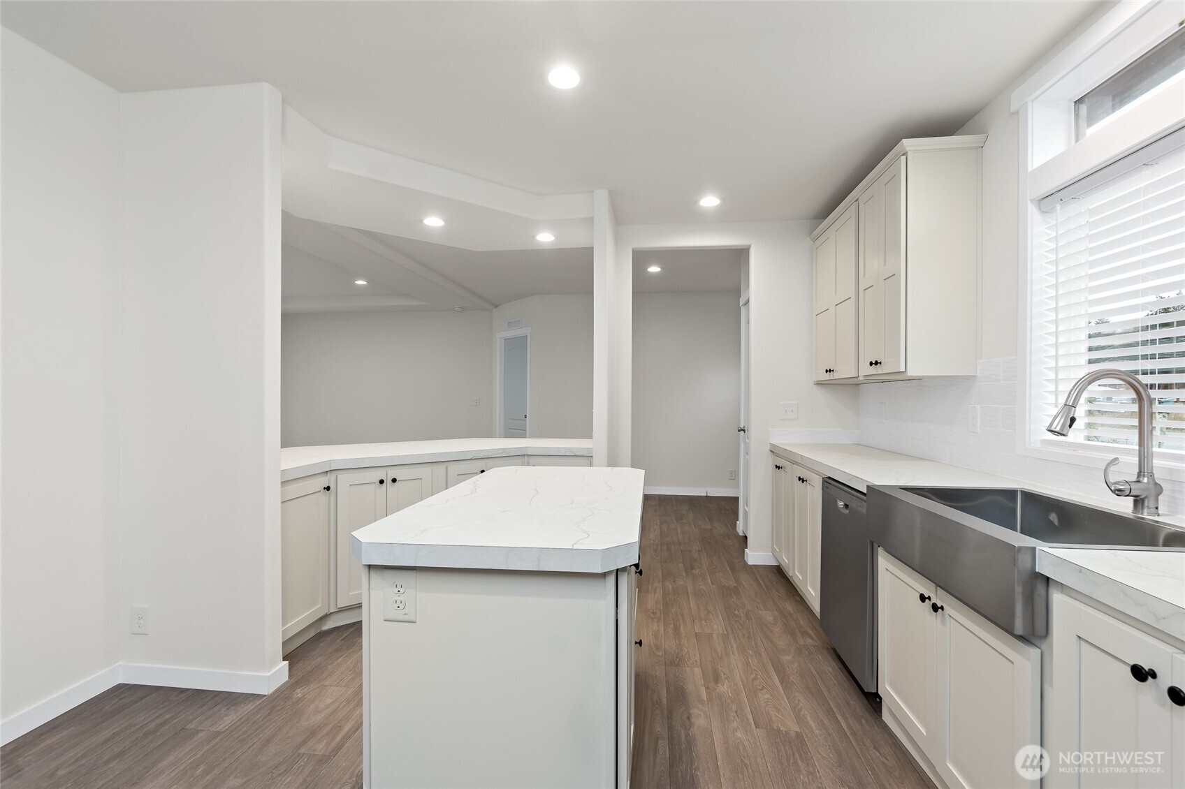 309 Sumner Street Bucoda, WA 98530 - Photo 14 of 35 a kitchen with a sink a wooden floor and white stainless steel appliances