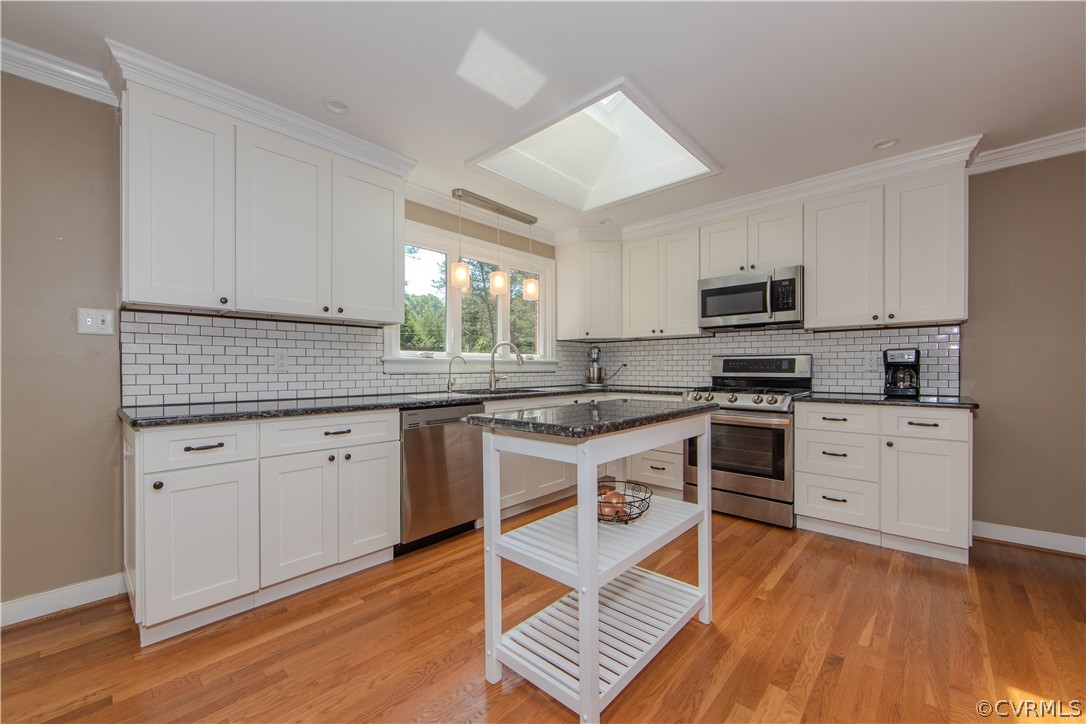 7706 Comanche Drive Richmond, VA 23225 - Photo 11 of 42 a kitchen with stainless steel appliances granite countertop a stove sink and cabinets