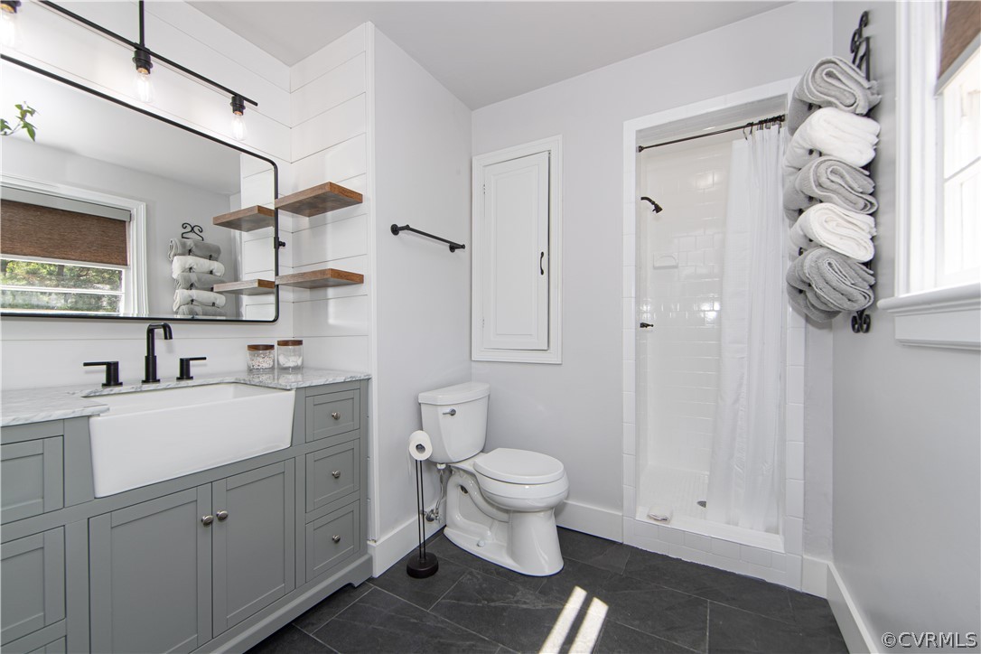 7706 Comanche Drive Richmond, VA 23225 - Photo 15 of 42 a bathroom with a sink a toilet and shower